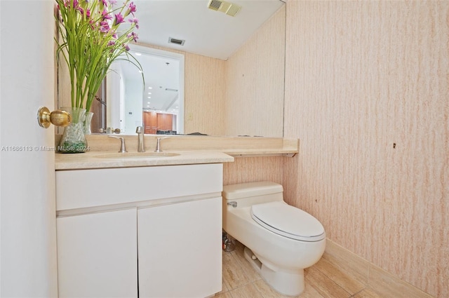 bathroom featuring toilet, vanity, and tile patterned floors