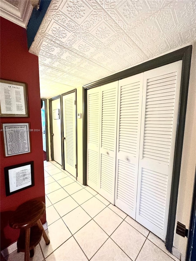 corridor with light tile patterned floors