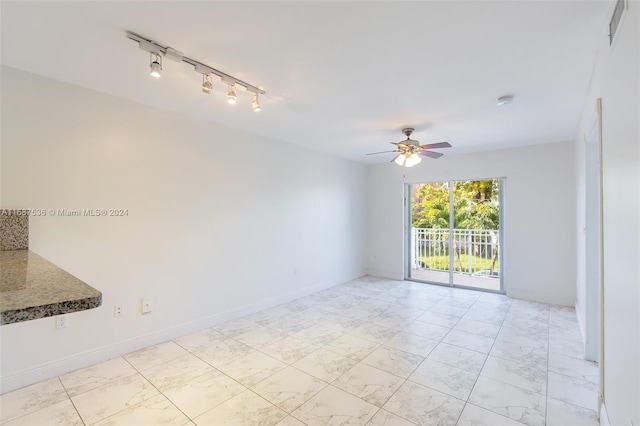 spare room featuring track lighting and ceiling fan