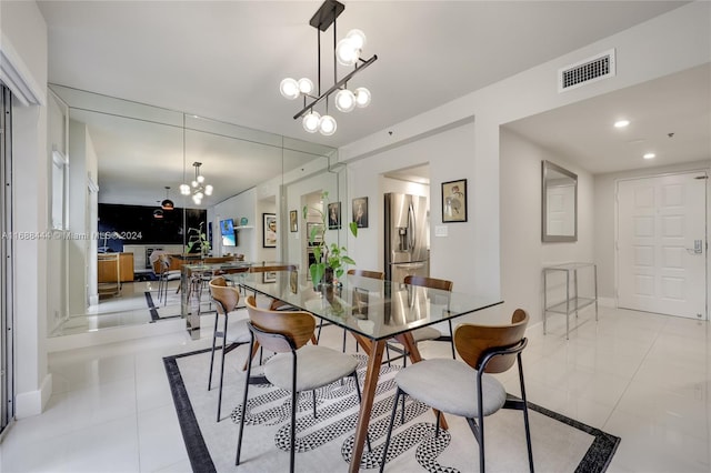 tiled dining area featuring a notable chandelier