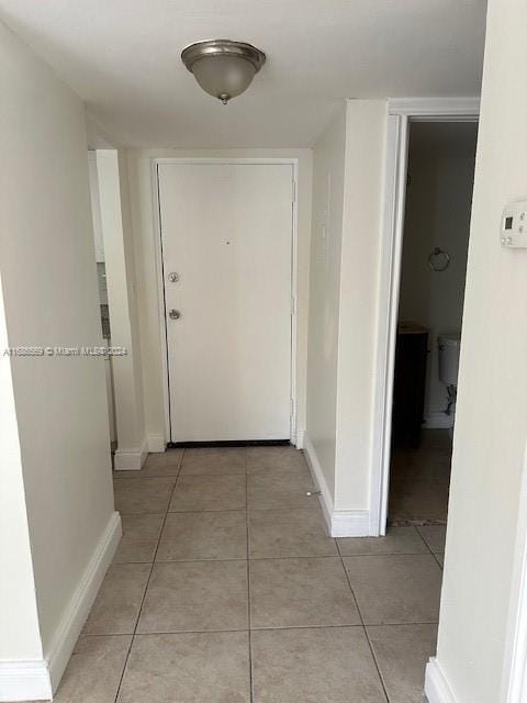 hall with light tile patterned floors