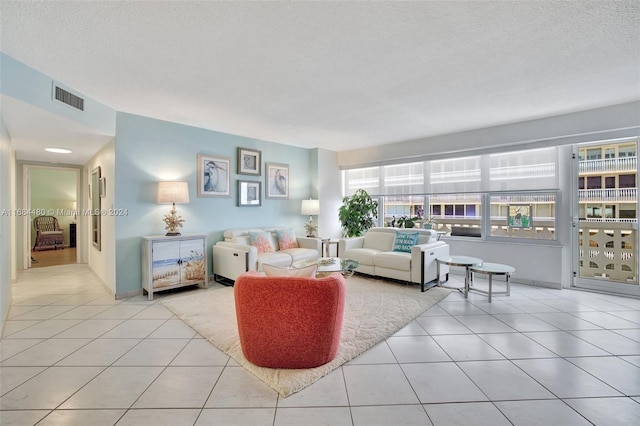 tiled living room with a textured ceiling