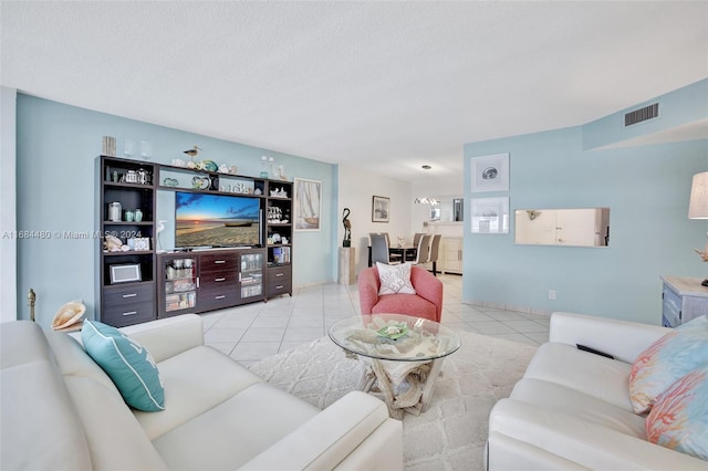 tiled living room featuring a textured ceiling