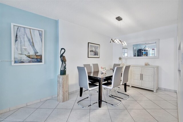 tiled dining space with a textured ceiling