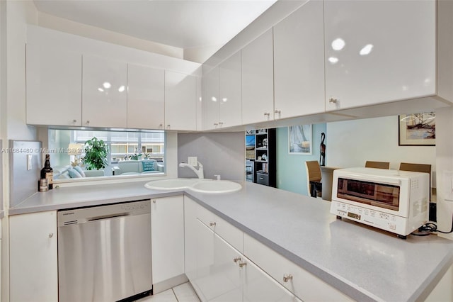 kitchen featuring dishwasher, white cabinetry, and sink