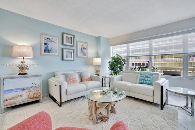 living room featuring tile patterned flooring and a textured ceiling