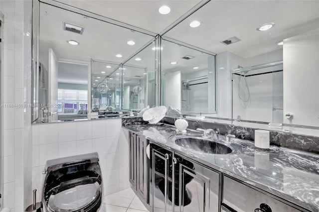 bathroom featuring walk in shower, vanity, toilet, and tile patterned flooring