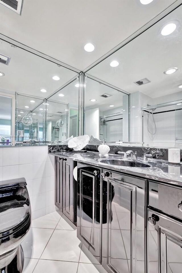 bathroom with vanity, tile patterned floors, and a shower with door