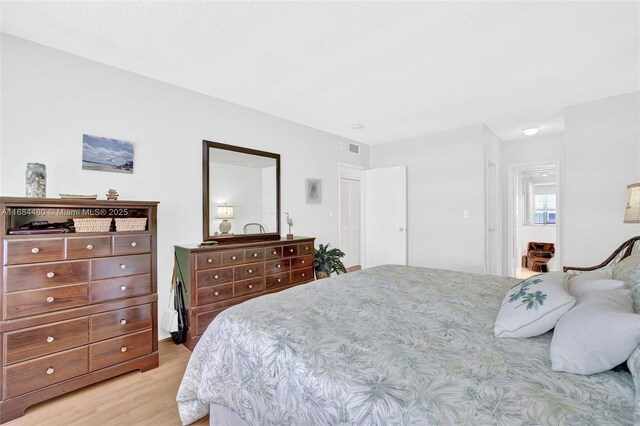 bedroom with a closet and light hardwood / wood-style flooring