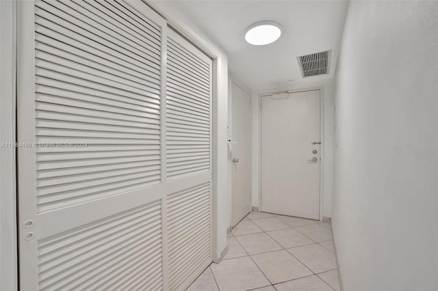 hall featuring light tile patterned floors