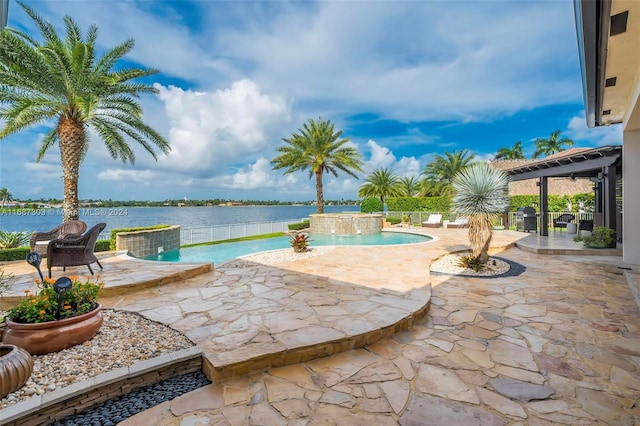 view of swimming pool featuring a patio, a water view, and pool water feature