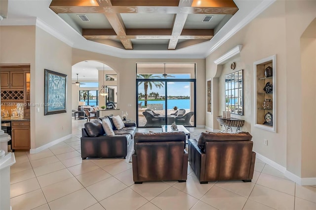 tiled living room with a water view, a healthy amount of sunlight, coffered ceiling, and ornamental molding