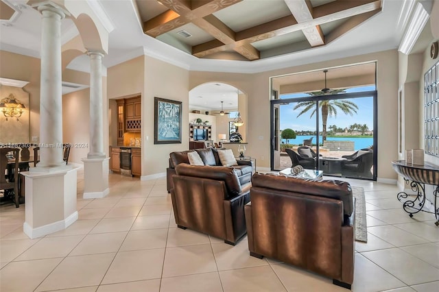 tiled living room with beam ceiling, ornate columns, ceiling fan, coffered ceiling, and crown molding