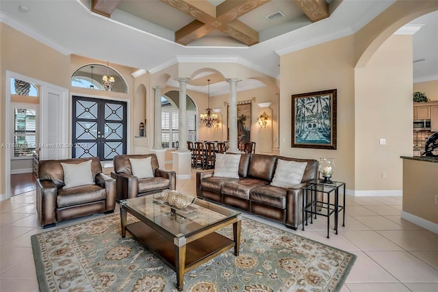 living room with ornate columns, coffered ceiling, crown molding, a chandelier, and light tile patterned flooring