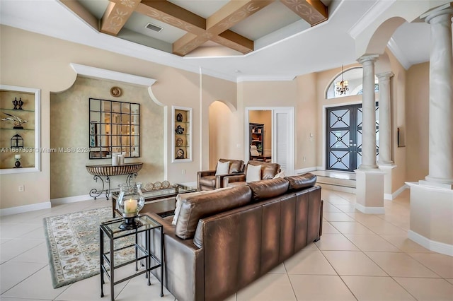 tiled living room with beam ceiling, decorative columns, and coffered ceiling