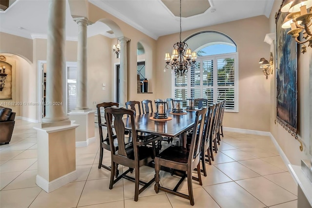 dining area with light tile patterned floors, decorative columns, an inviting chandelier, and crown molding