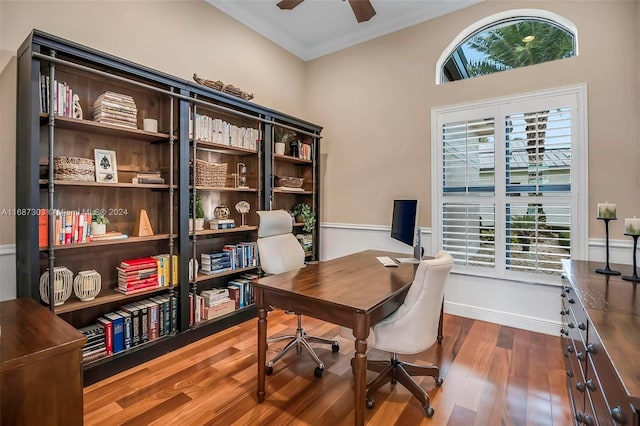 home office with ceiling fan, ornamental molding, and hardwood / wood-style flooring