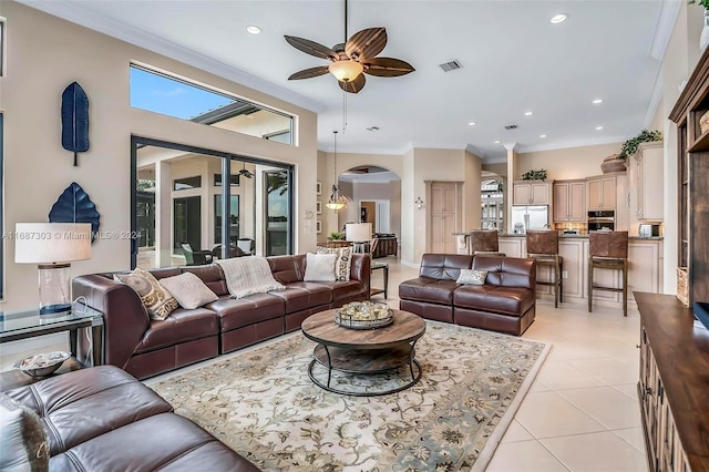 living room featuring a wealth of natural light, crown molding, and ceiling fan