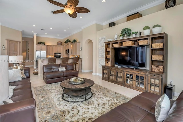 living room with ceiling fan, crown molding, and light tile patterned flooring