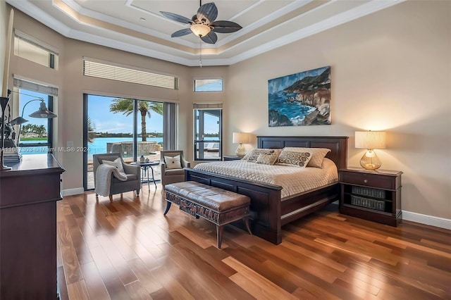 bedroom featuring a water view, crown molding, ceiling fan, and dark wood-type flooring