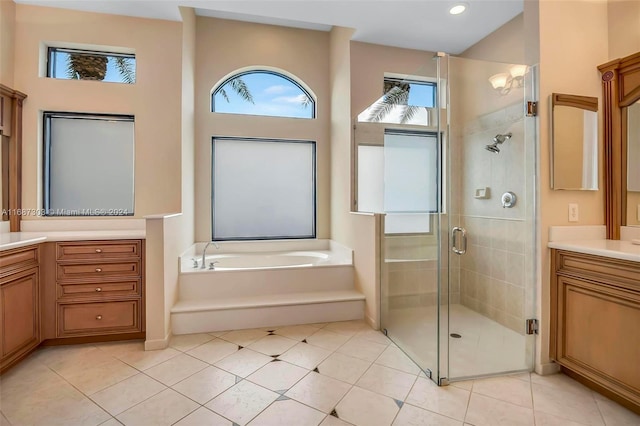 bathroom featuring vanity and independent shower and bath