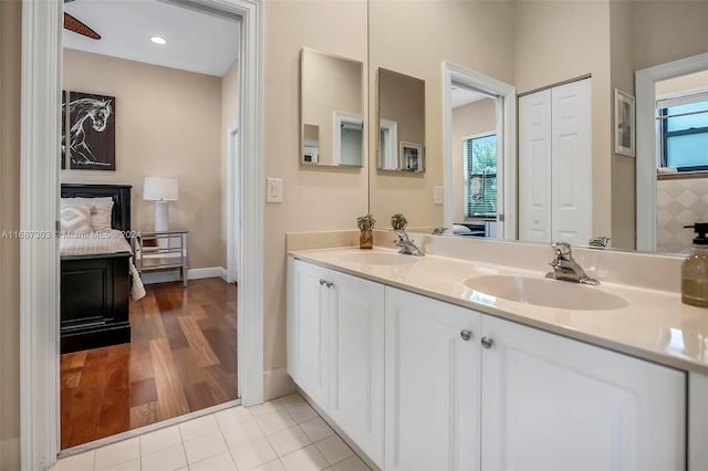 bathroom featuring wood-type flooring, vanity, and a healthy amount of sunlight