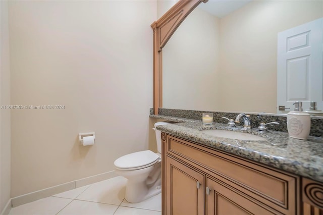 bathroom featuring tile patterned floors, vanity, and toilet