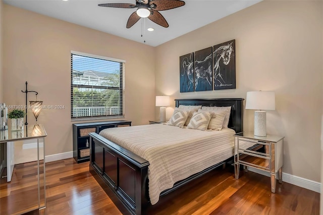 bedroom with ceiling fan and dark wood-type flooring