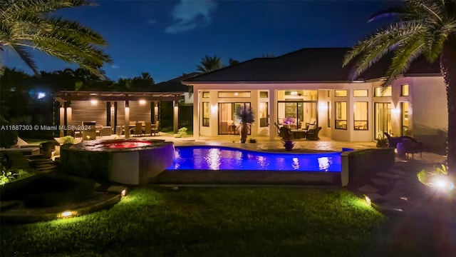 pool at twilight with a patio area