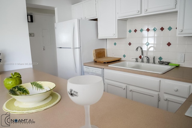 kitchen featuring white cabinetry, white appliances, sink, and tasteful backsplash