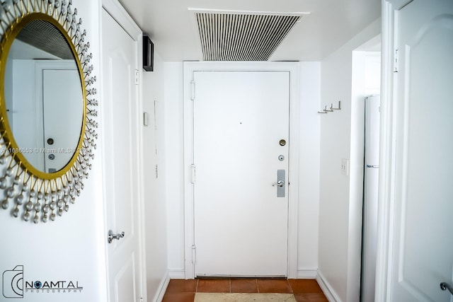 doorway to outside with tile patterned flooring