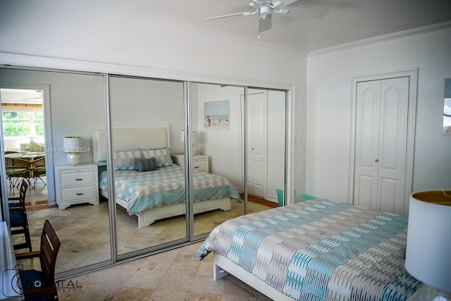 bedroom with multiple closets, ceiling fan, and crown molding