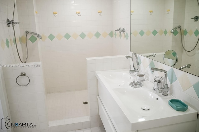 bathroom featuring vanity and tiled shower