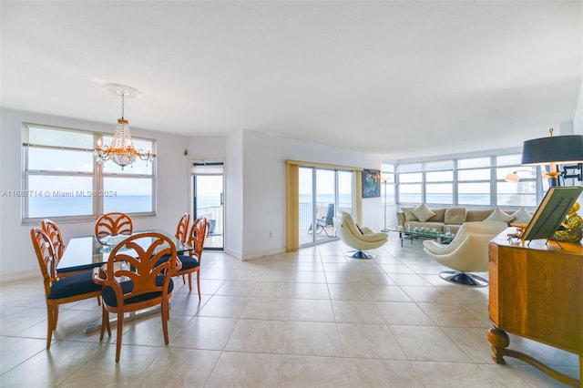 tiled dining area with an inviting chandelier