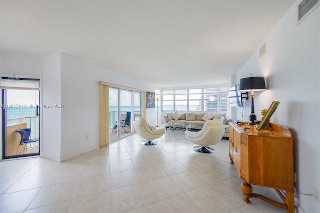 tiled living room featuring a water view