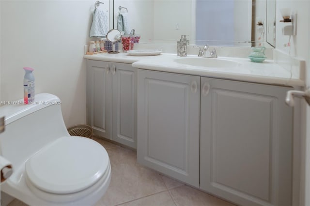 bathroom featuring toilet, vanity, and tile patterned flooring