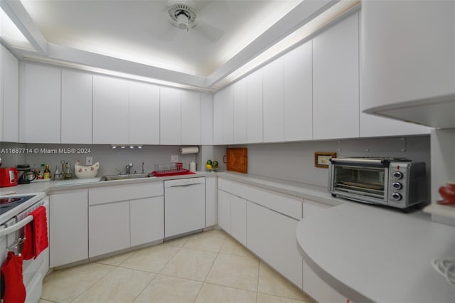 kitchen with white cabinets, white appliances, light tile patterned floors, and sink