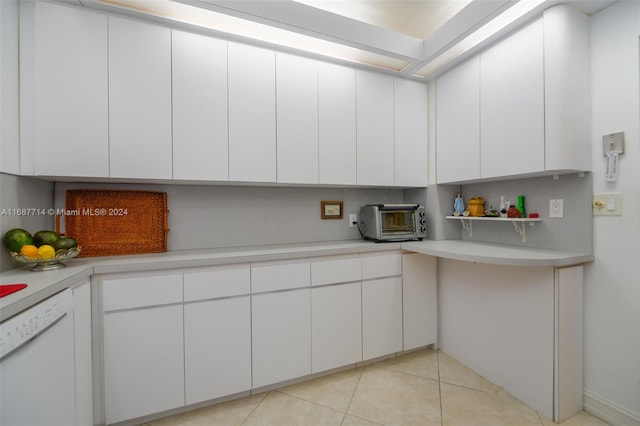 kitchen featuring white cabinets, light tile patterned floors, and dishwasher