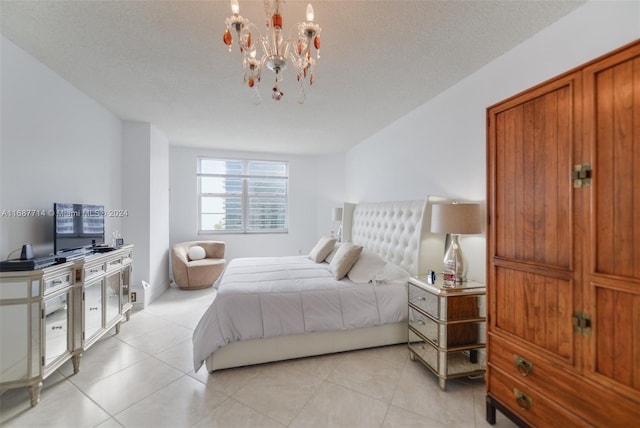 tiled bedroom with a textured ceiling and a notable chandelier