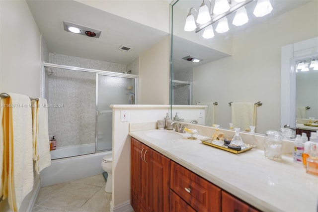 full bathroom featuring toilet, combined bath / shower with glass door, vanity, and tile patterned flooring