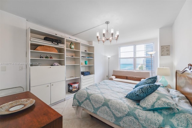 bedroom featuring light tile patterned floors and an inviting chandelier