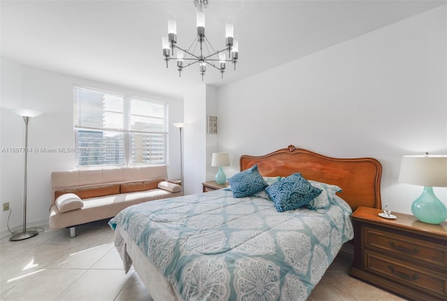 tiled bedroom featuring an inviting chandelier