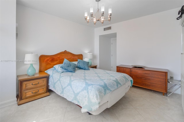 tiled bedroom with an inviting chandelier