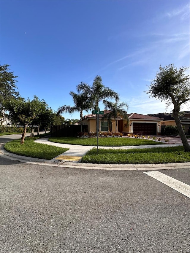 view of front facade featuring a garage and a front lawn