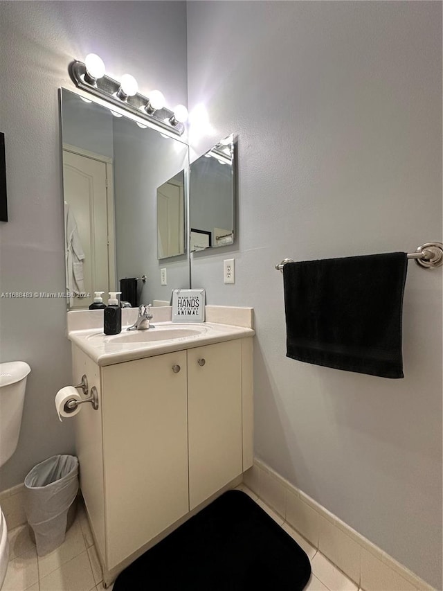 bathroom featuring vanity, tile patterned floors, and toilet