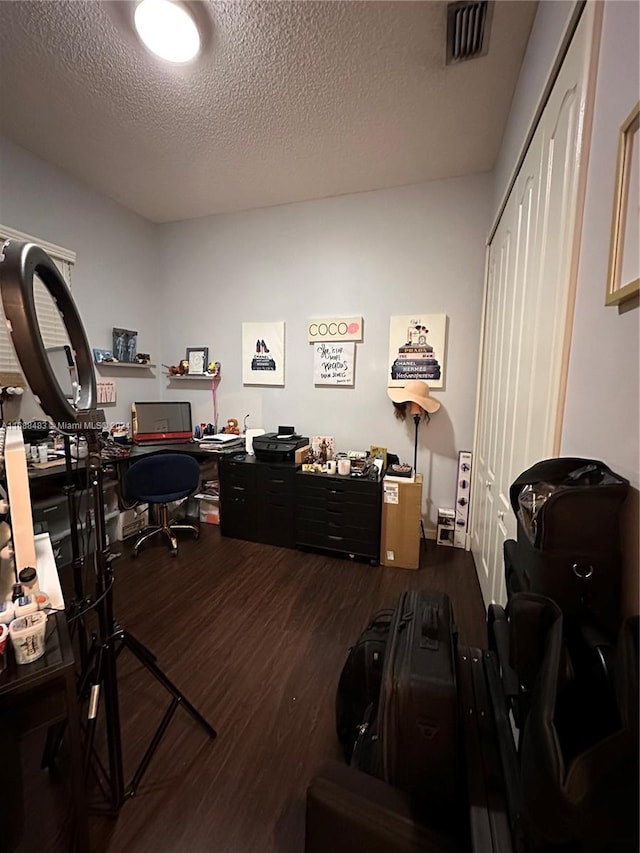 office area with dark hardwood / wood-style flooring and a textured ceiling