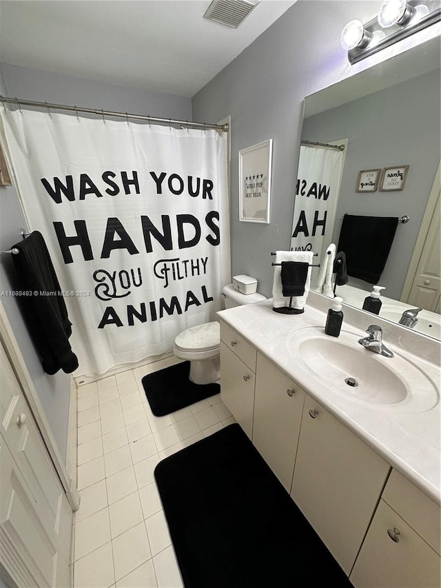 bathroom featuring toilet, vanity, and tile patterned floors