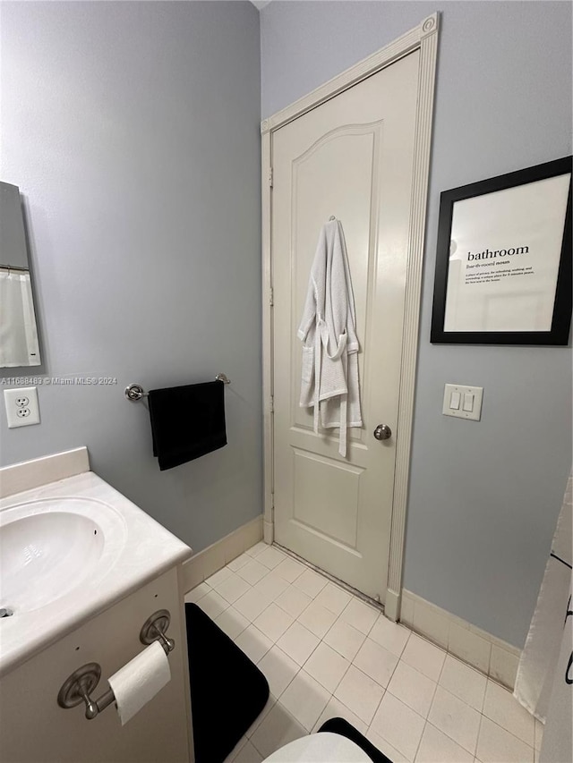 bathroom featuring tile patterned flooring and vanity