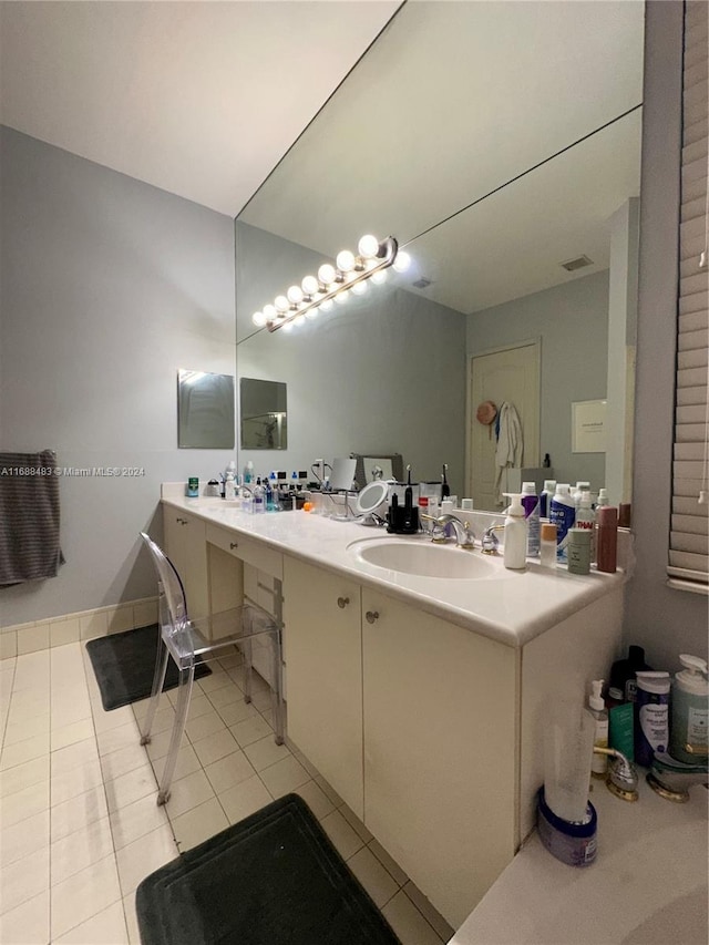 bathroom featuring tile patterned flooring and vanity