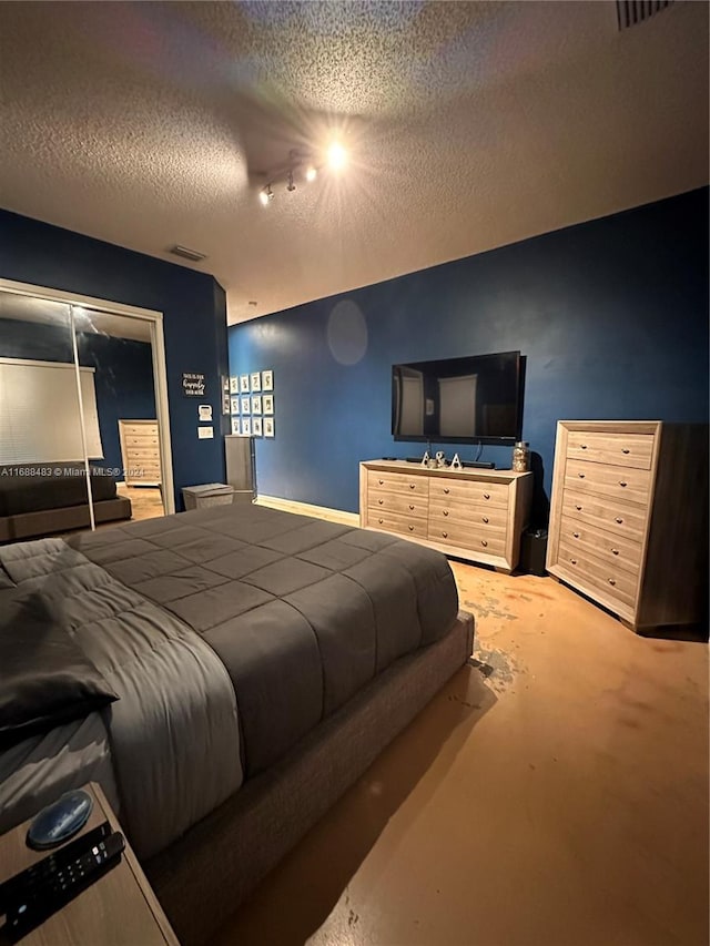 bedroom with a closet and a textured ceiling